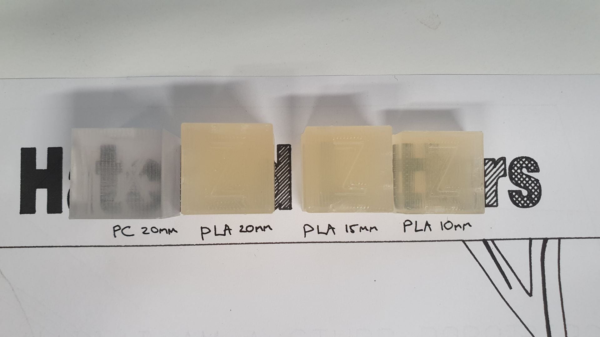 3D Printed cubes showing the transparency of Polycarbonate and various thicknesses of PLA prints